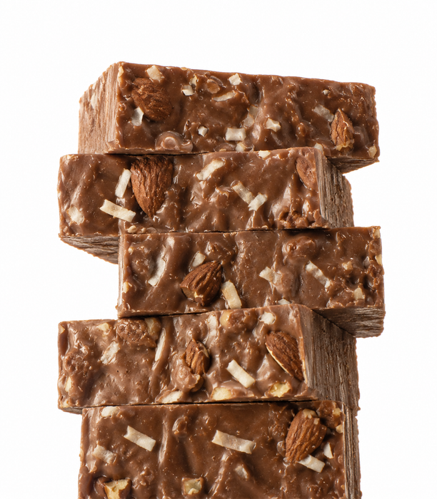 A stack of five almond coconut Fudge slices topped with sliced almonds and white chocolate shavings, isolated on a white background.