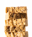Stack of gourmet Butter Pecan Fudge with visible nuts on a white background