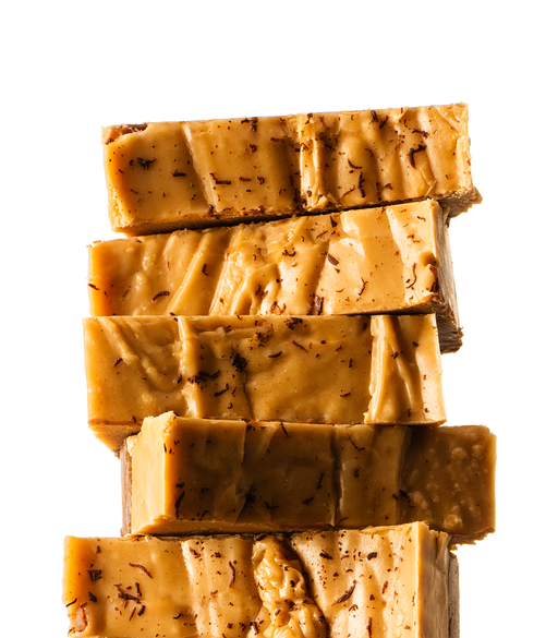 Stack of handmade Chocolate Peanut Butter Fudge on a white background
