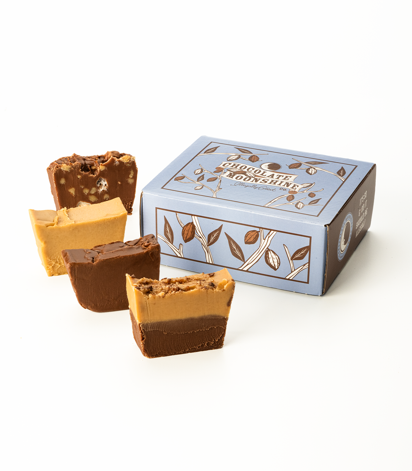 Four slices of gourmet fudge in front of a box labeled Chocolate Moonshine on a white background