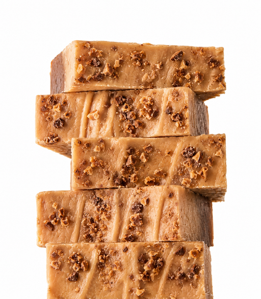 Stack of toffee fudge slices with nuts on a white background
