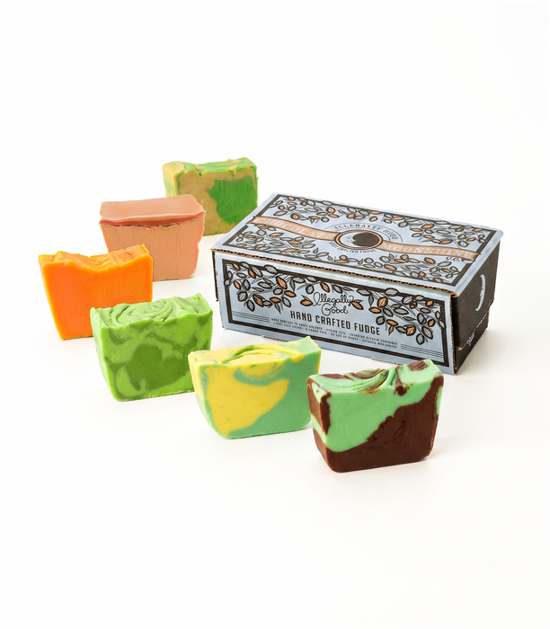 Six hand-crafted pickle fudge slices in various colorful swirl patterns are arranged around a box on a clean white background. The box is labeled 'Hand Crafted Fudge' and features the brand name 'Chocolate Moonshine' at the top.