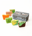 Six hand-crafted pickle fudge slices in various colorful swirl patterns are arranged around a box on a clean white background. The box is labeled 'Hand Crafted Fudge' and features the brand name 'Chocolate Moonshine' at the top.