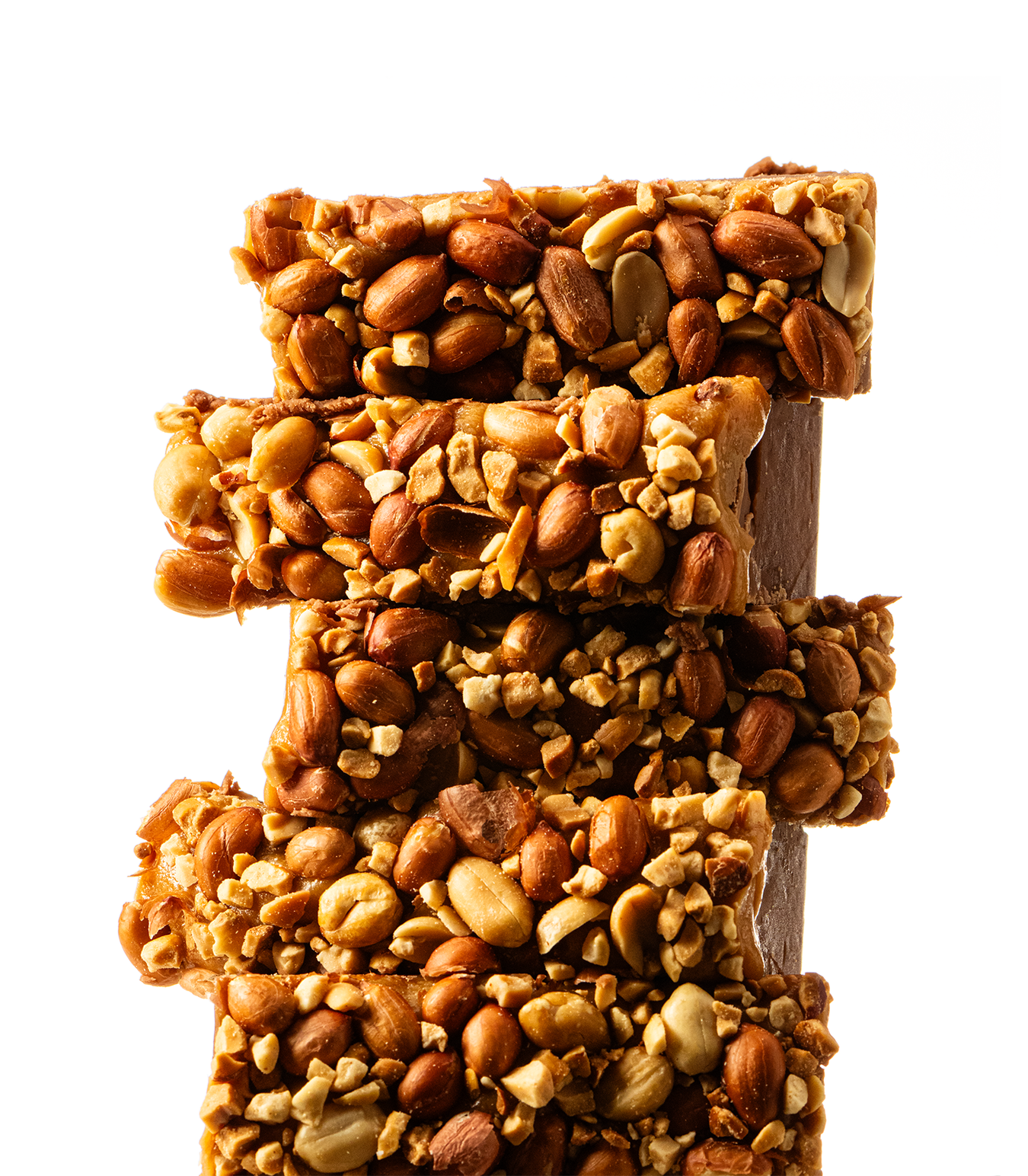 Stack of Snickers Fudge with nuts on top, on a white background.